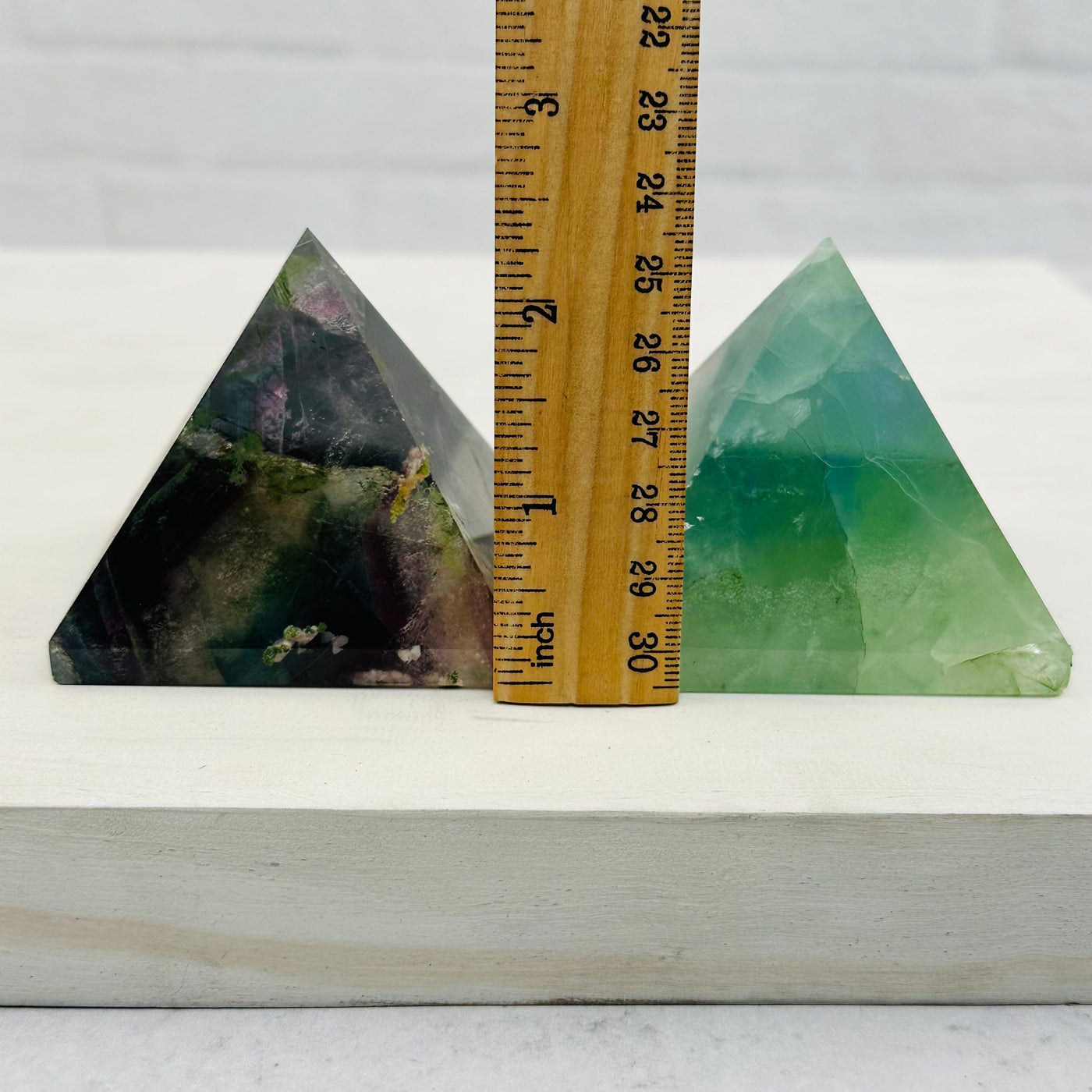 pyramids next to a ruler for size reference