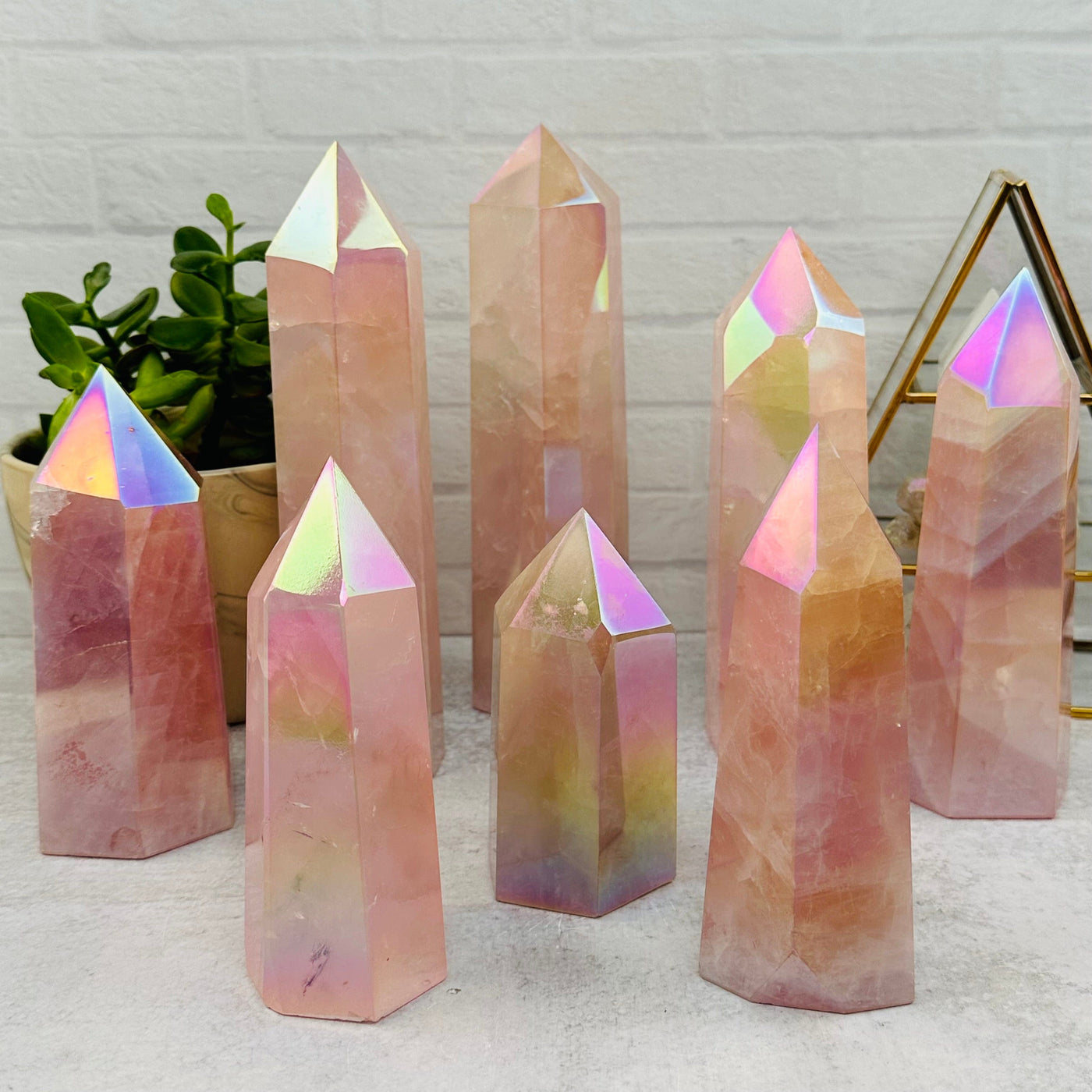 multipleAngel Aura Rose Quartz Polished Towers displayed to show the differences in the sizes available 