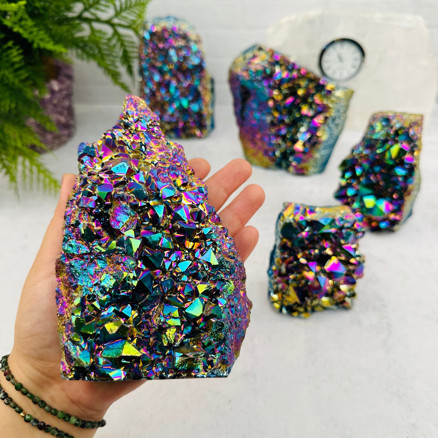 Amethyst Druzy Cutbase with Rainbow Titanium Finish in hand for size reference 