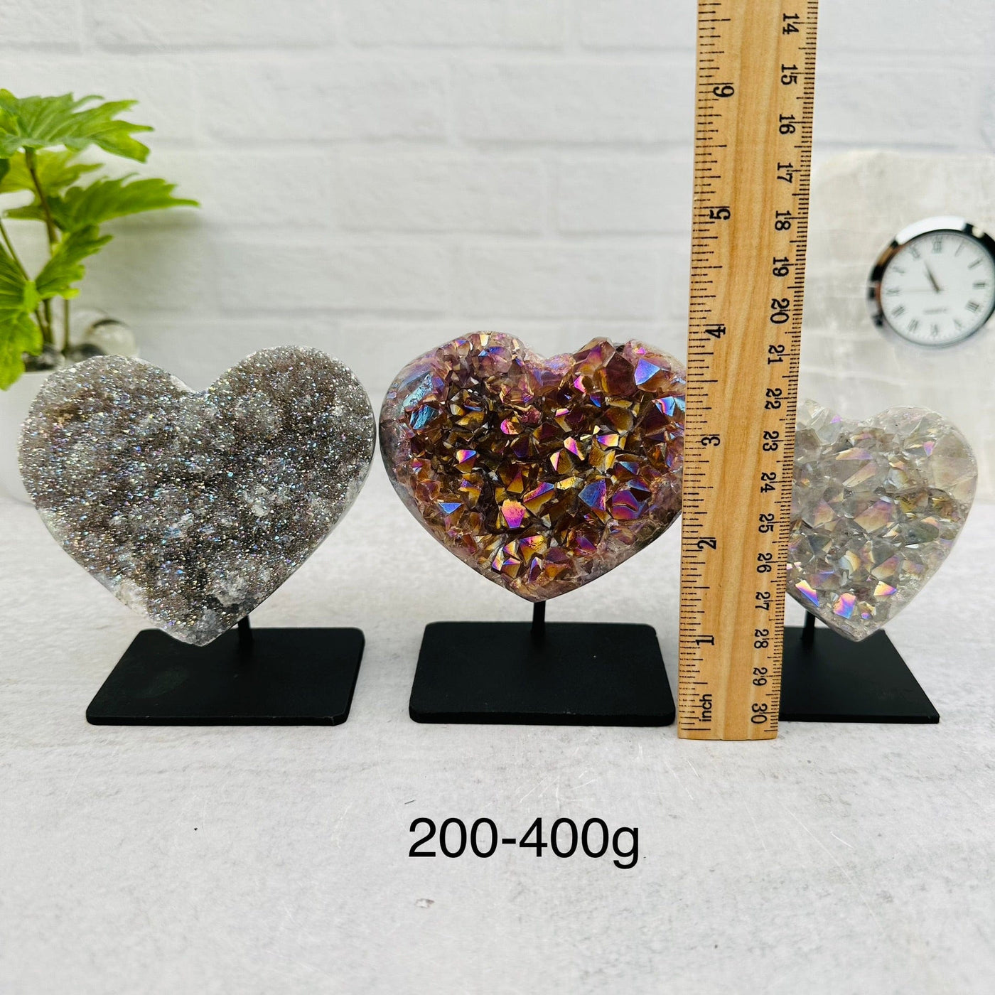 Amethyst Druzy Crystal Heart with Angel Aura on Metal Stand by weight. next to a ruler for size reference 