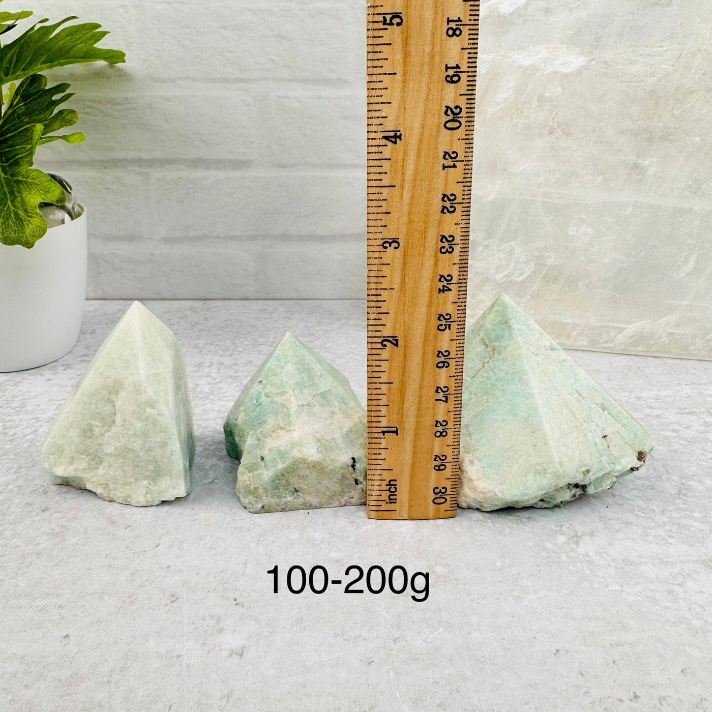Amazonite Semi Polished Point - By Weight - next to a ruler for size reference 