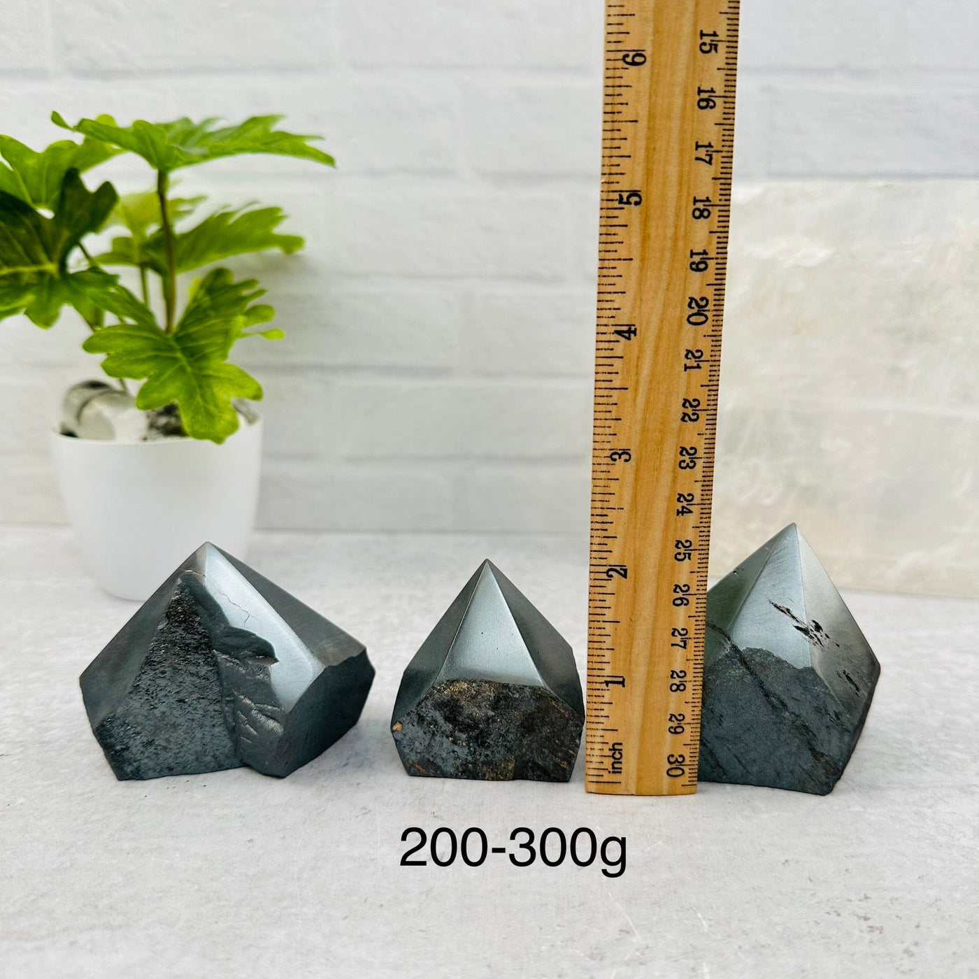 Hematite Semi-Polished Points - By Weight next to a ruler for size reference 