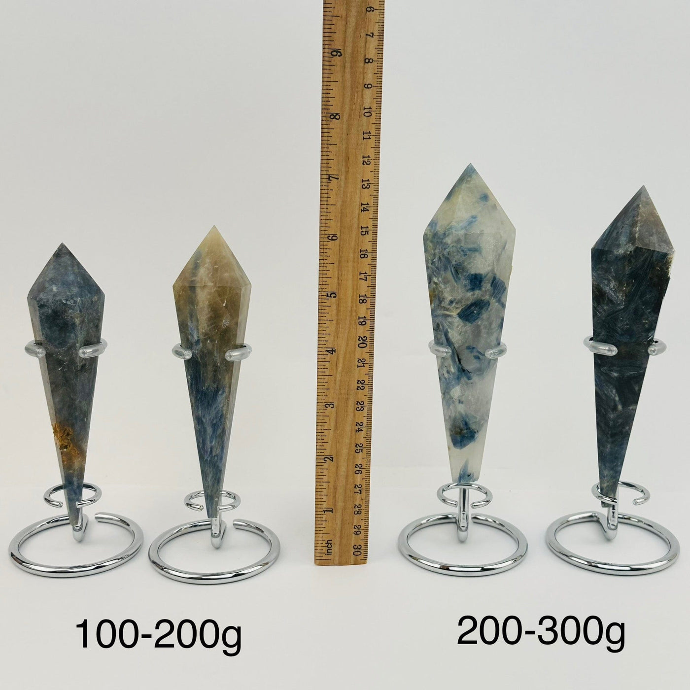 crystal wands on metal stand are sold by weight. displayed next to a ruler for size reference 