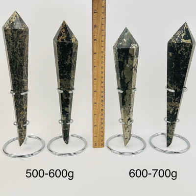 crystal wands on metal stand are sold by weight. displayed next to a ruler for size reference 