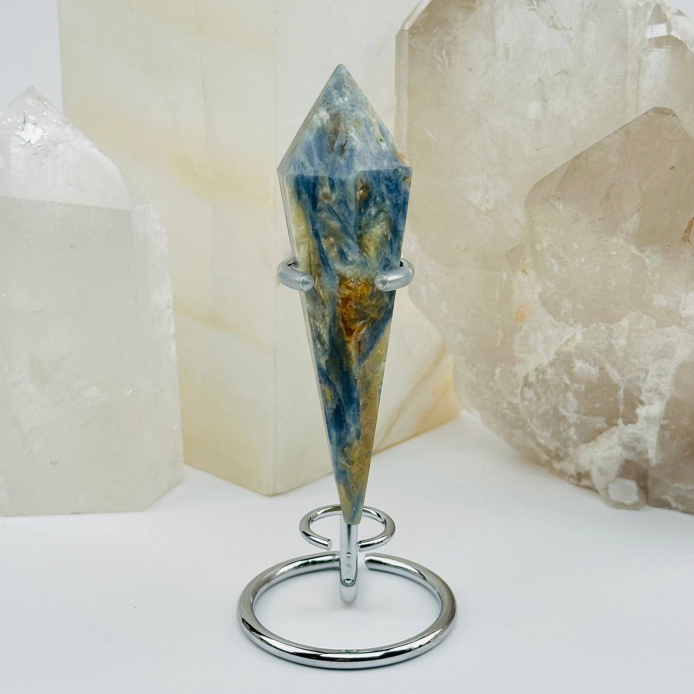 close up of the details on this kyanite wand on stand 
