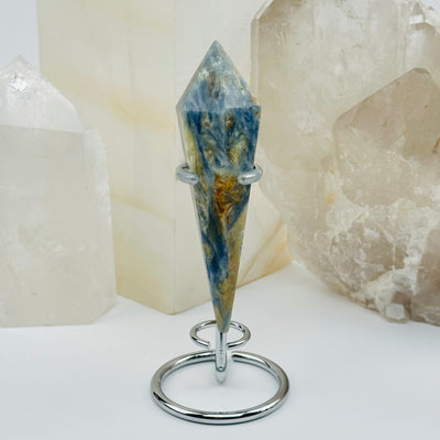 close up of the details on this kyanite wand on stand 