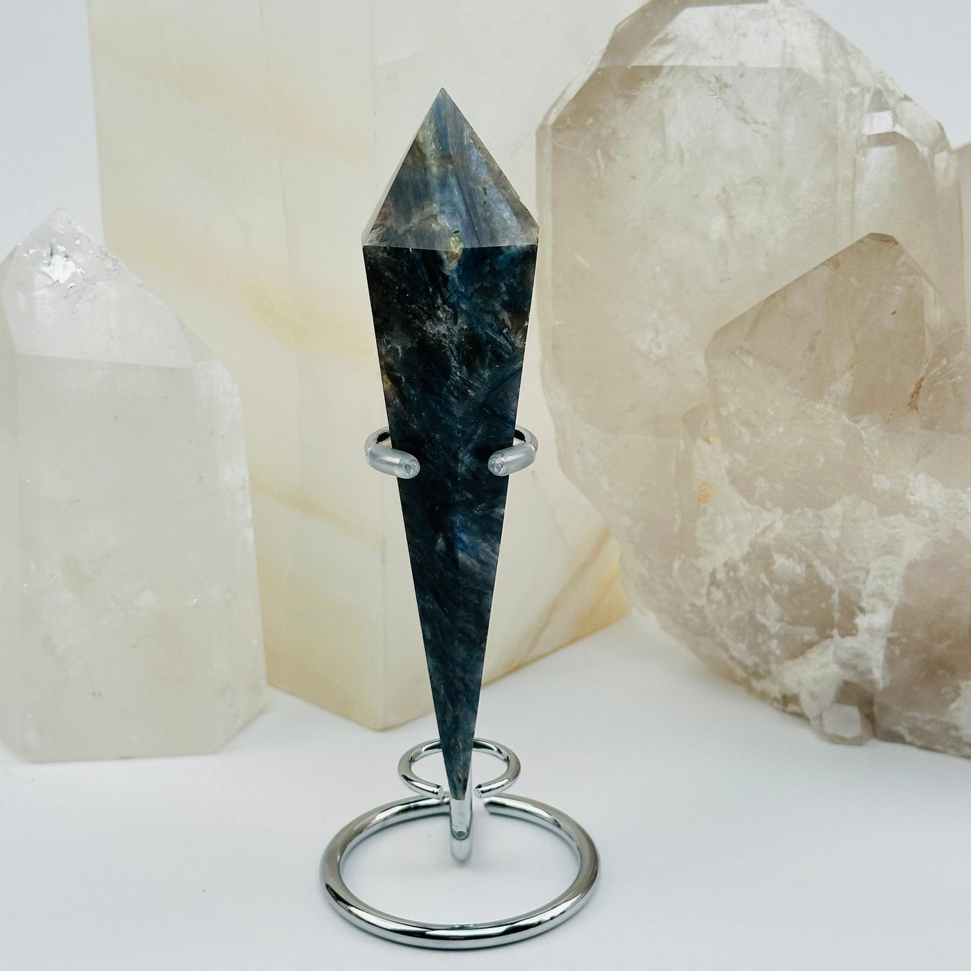 close up of the details on this kyanite wand on stand 