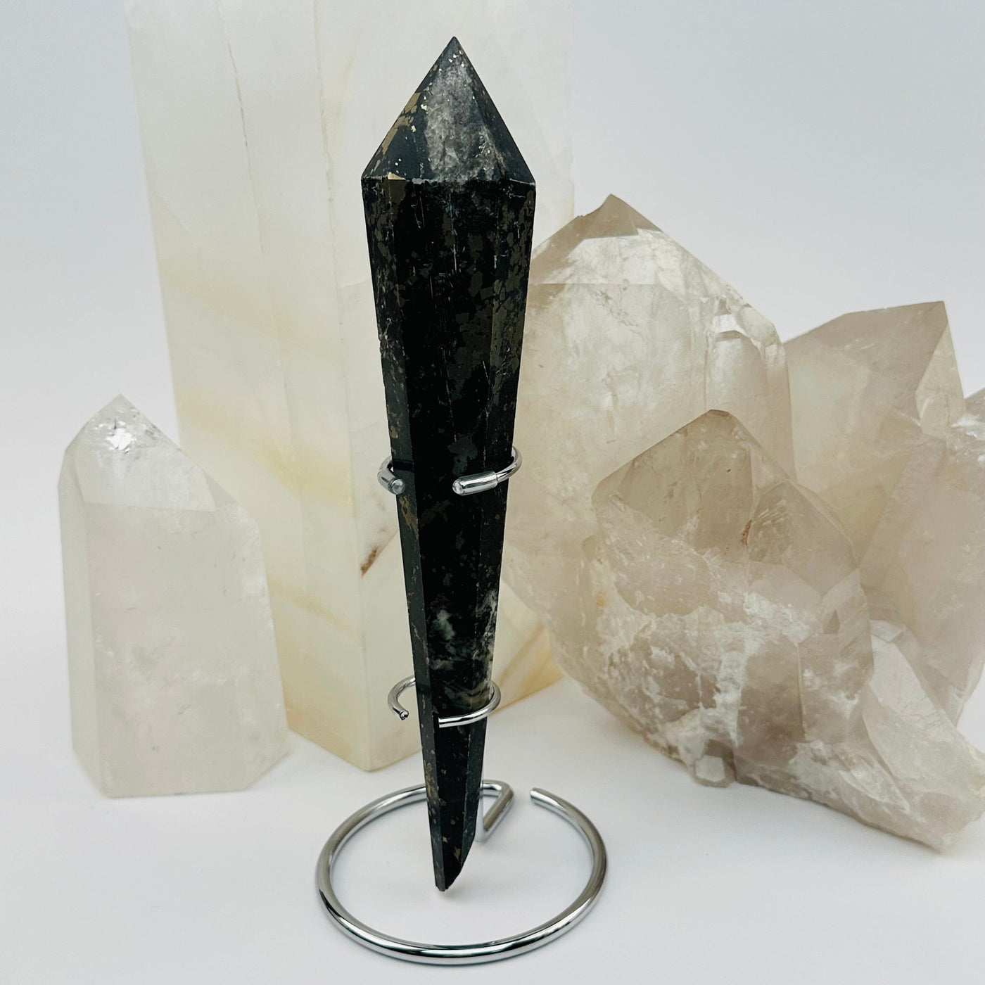 pyrite crystal wand on metal stand displayed as home decor