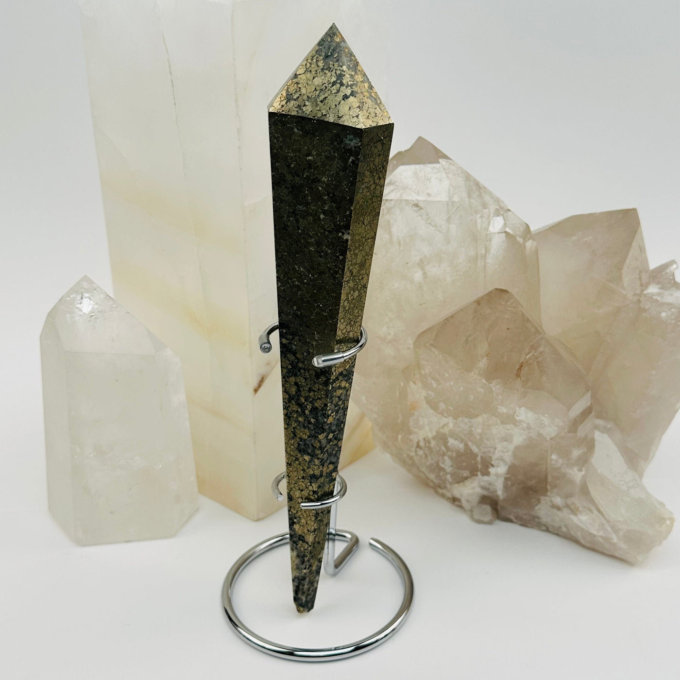 pyrite crystal wand on metal stand displayed as home decor
