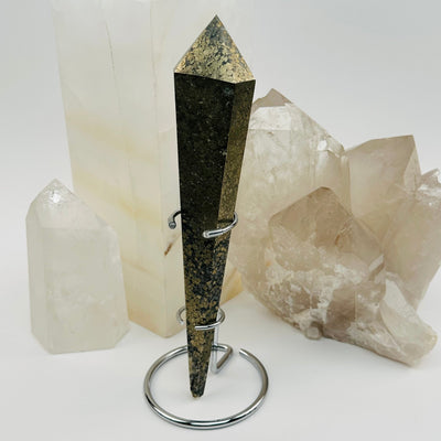 pyrite crystal wand on metal stand displayed as home decor
