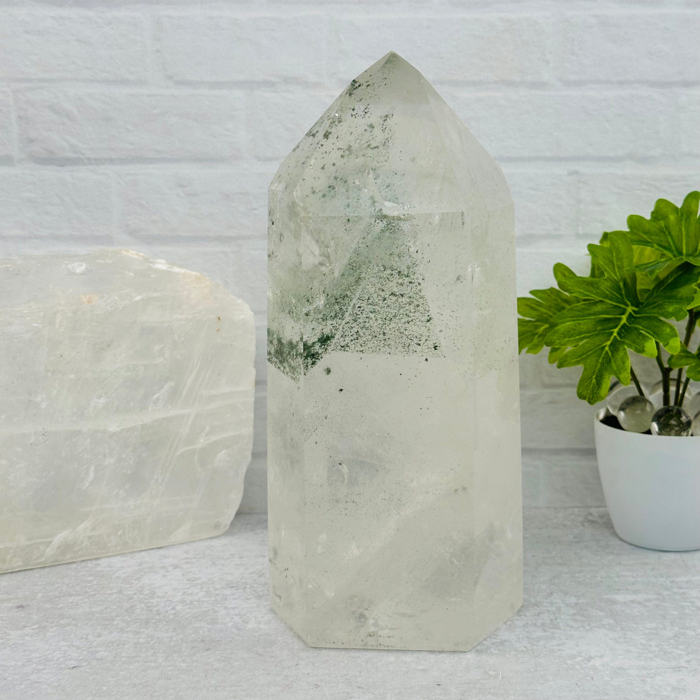 Large Crystal Quartz point with Green Chlorite Phantom displayed as home decor 