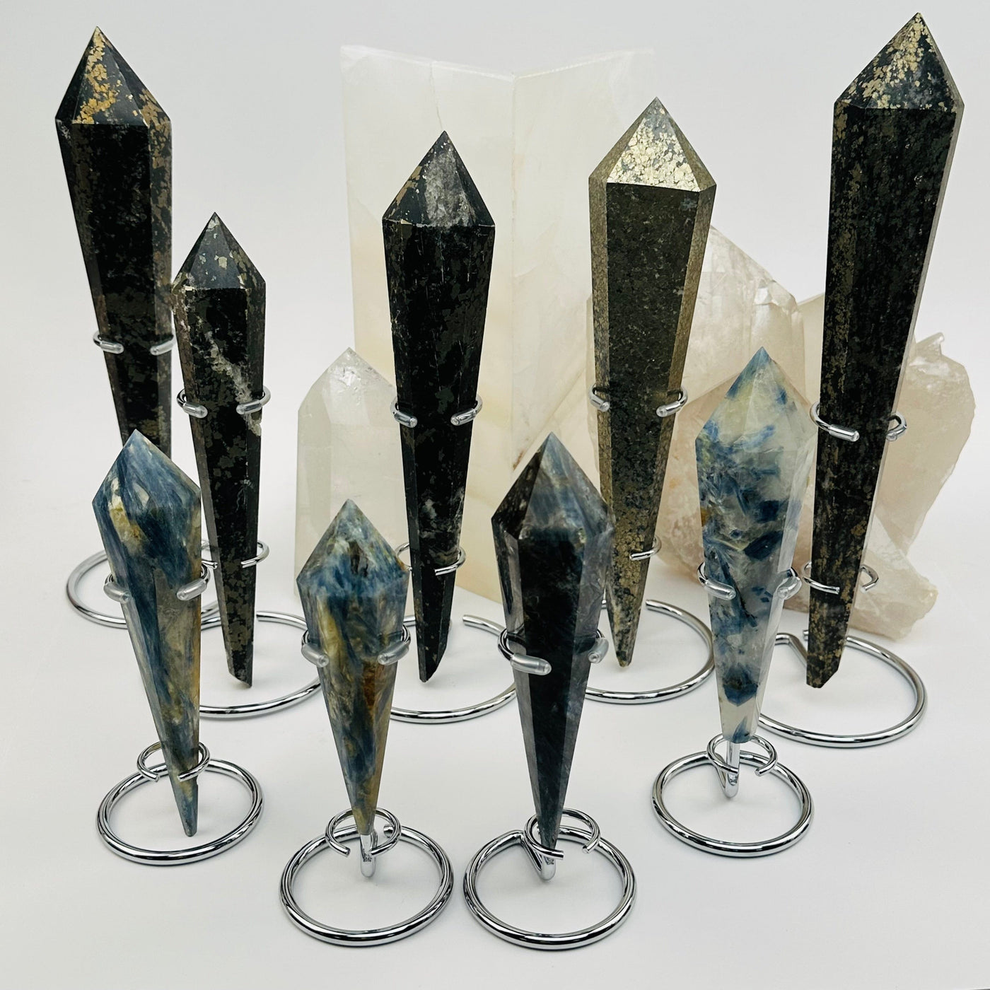 multiple crystal wands on stand displayed to show the differences in the crystal types and sizes 