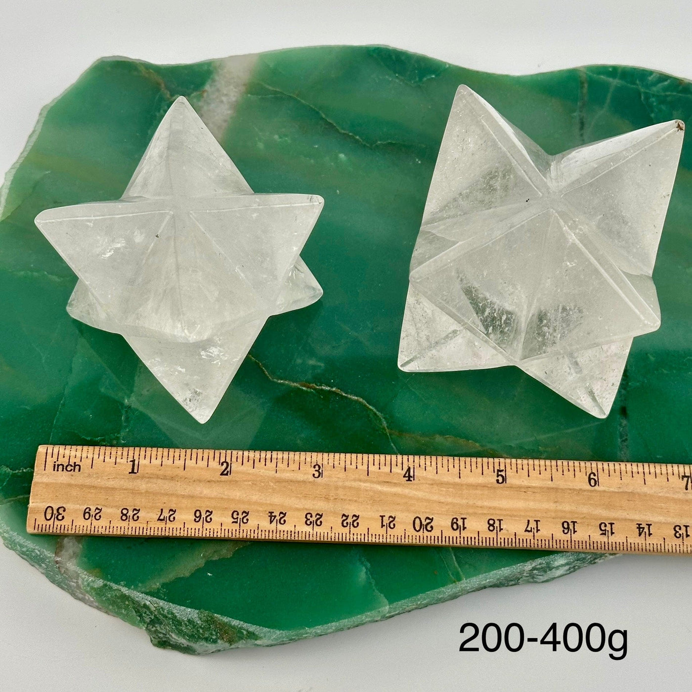 crystal quartz Merkabah stars displayed next to a ruler for size reference 