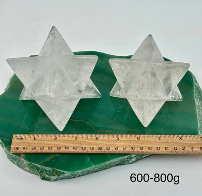 crystal quartz Merkabah stars displayed next to a ruler for size reference 
