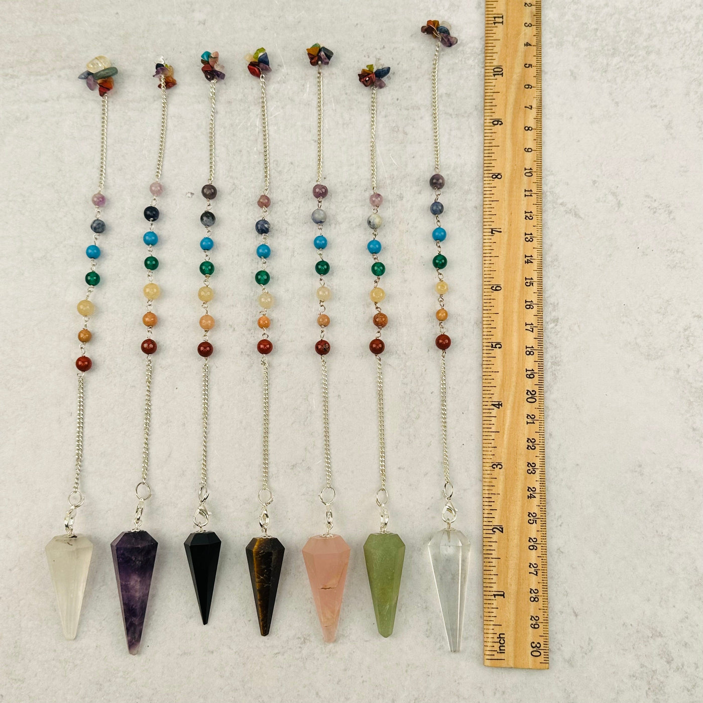 Crystal Pendulum on Chakra Chain next to a ruler for size reference 