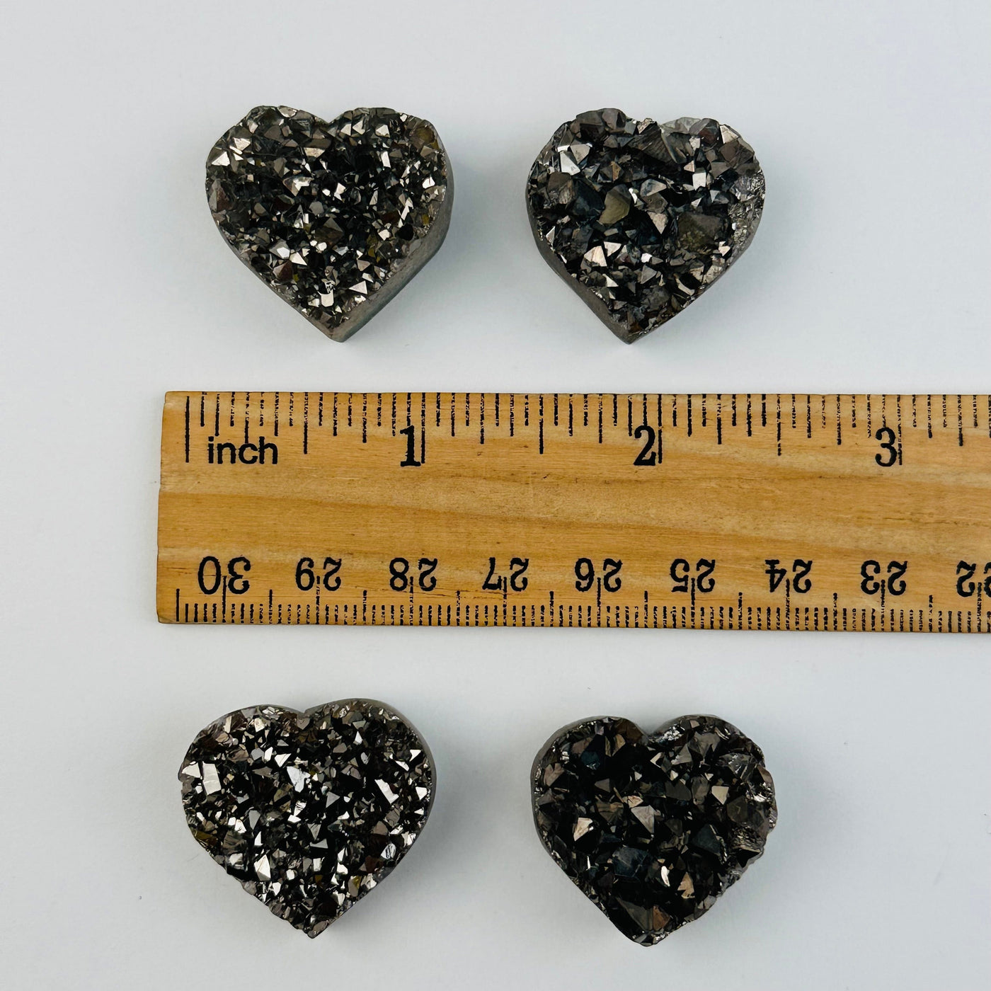 hearts next to a ruler for size reference 