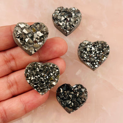 Platinum Titanium Hearts in hand for size reference 