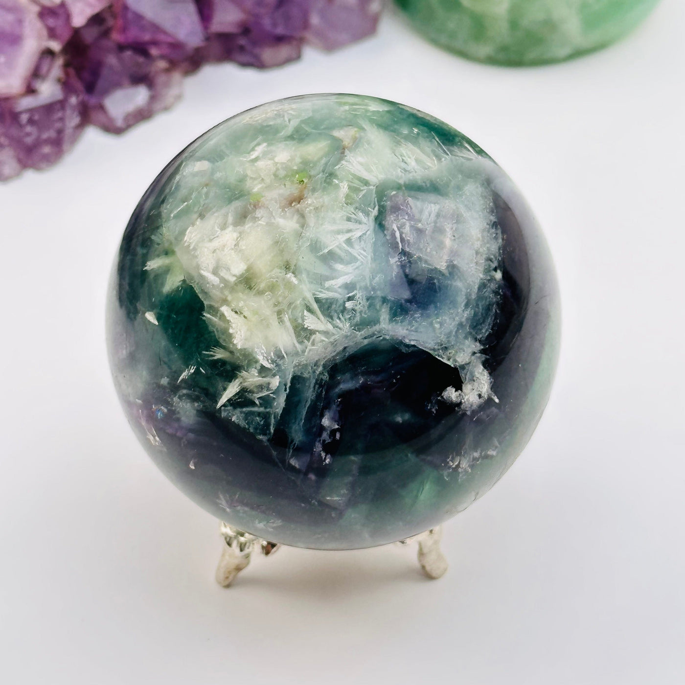 feather fluorite crystal sphere displayed as home decor