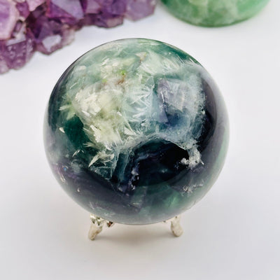 feather fluorite crystal sphere displayed as home decor