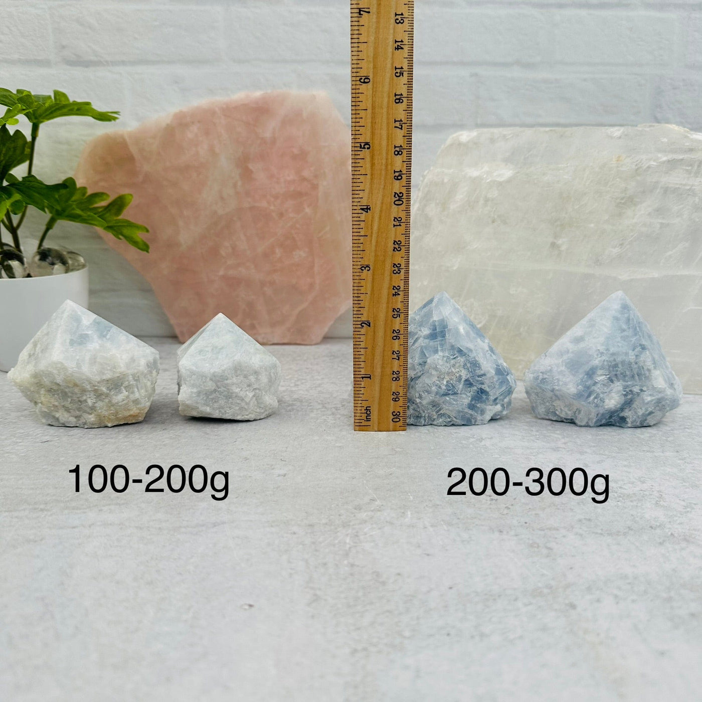Blue Calcite Semi-Polished Points - By Weight next to a ruler for size reference 