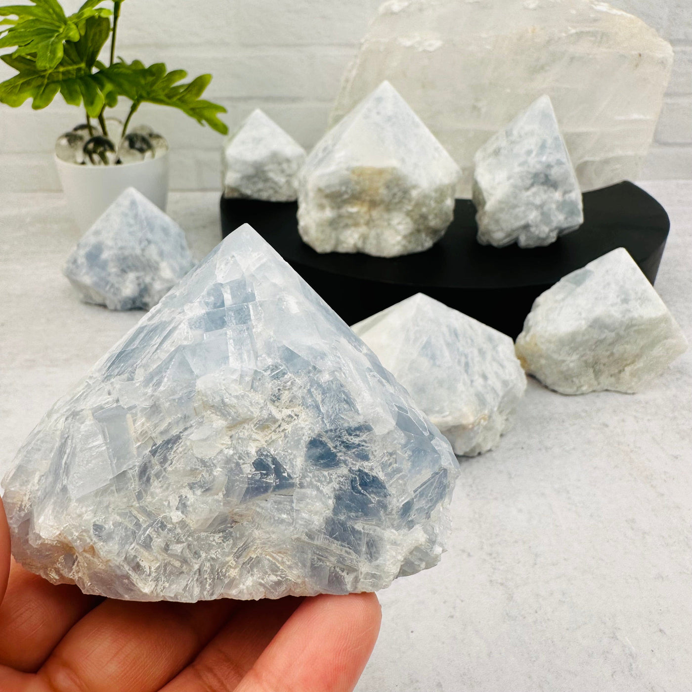 Blue Calcite Semi-Polished Point in hand for size reference 