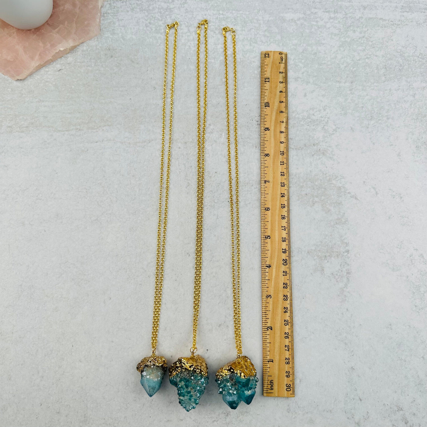 necklaces next to a ruler for size reference