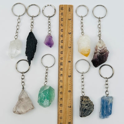 crystal key chains displayed next to a ruler for size reference 