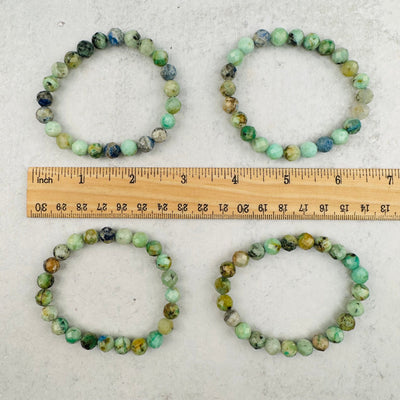 bracelets displayed next to a ruler for size reference 