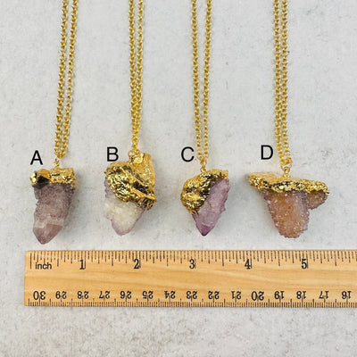 pendants displayed next to a ruler for size reference 