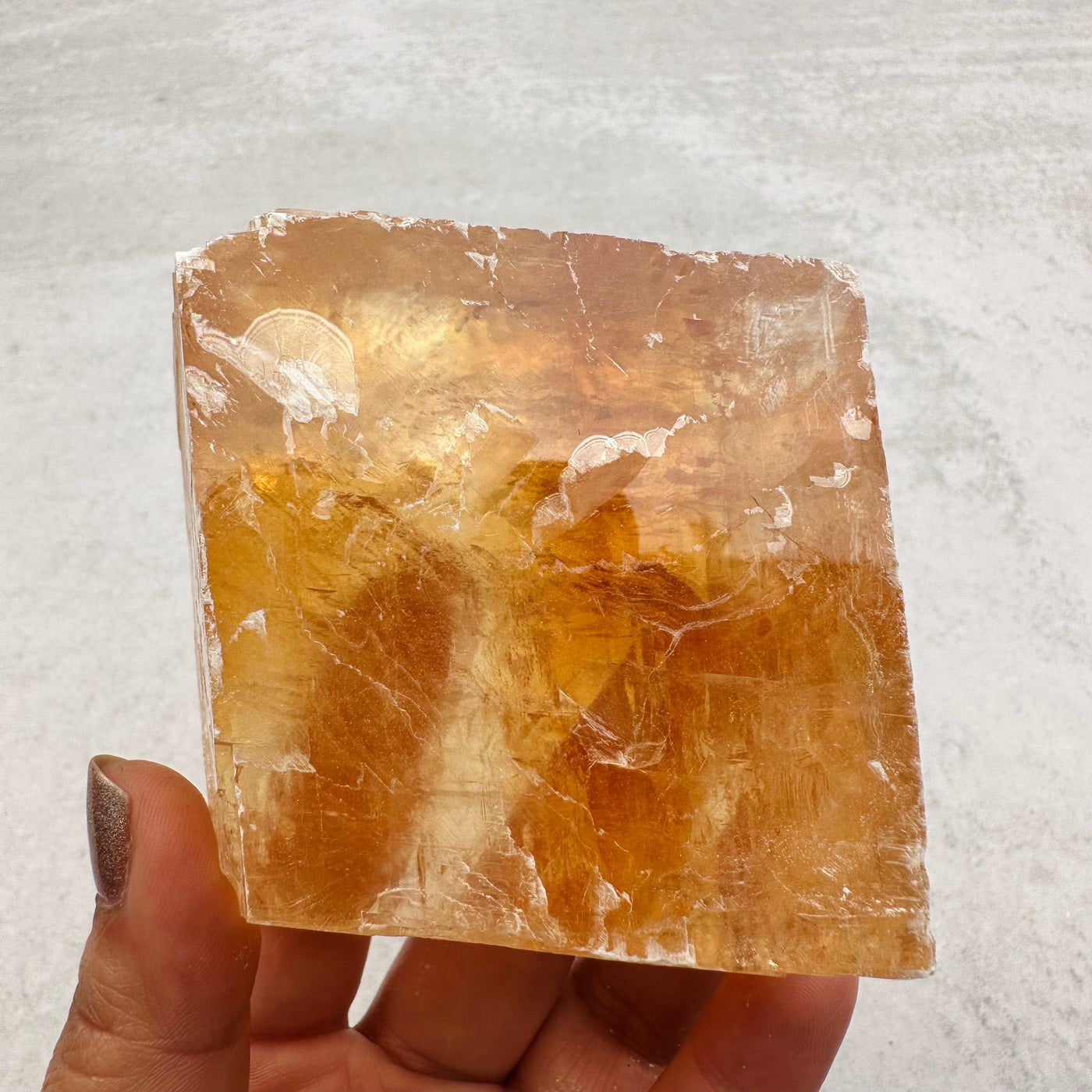 calcite piece in hand for size reference