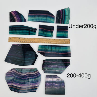 fluorite slabs sold by weight. displayed next to a ruler for size reference 