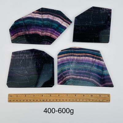 fluorite slabs sold by weight. displayed next to a ruler for size reference 