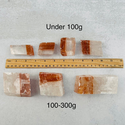 Optical Calcite - White/Red - You Choose Size next to a ruler for size reference 