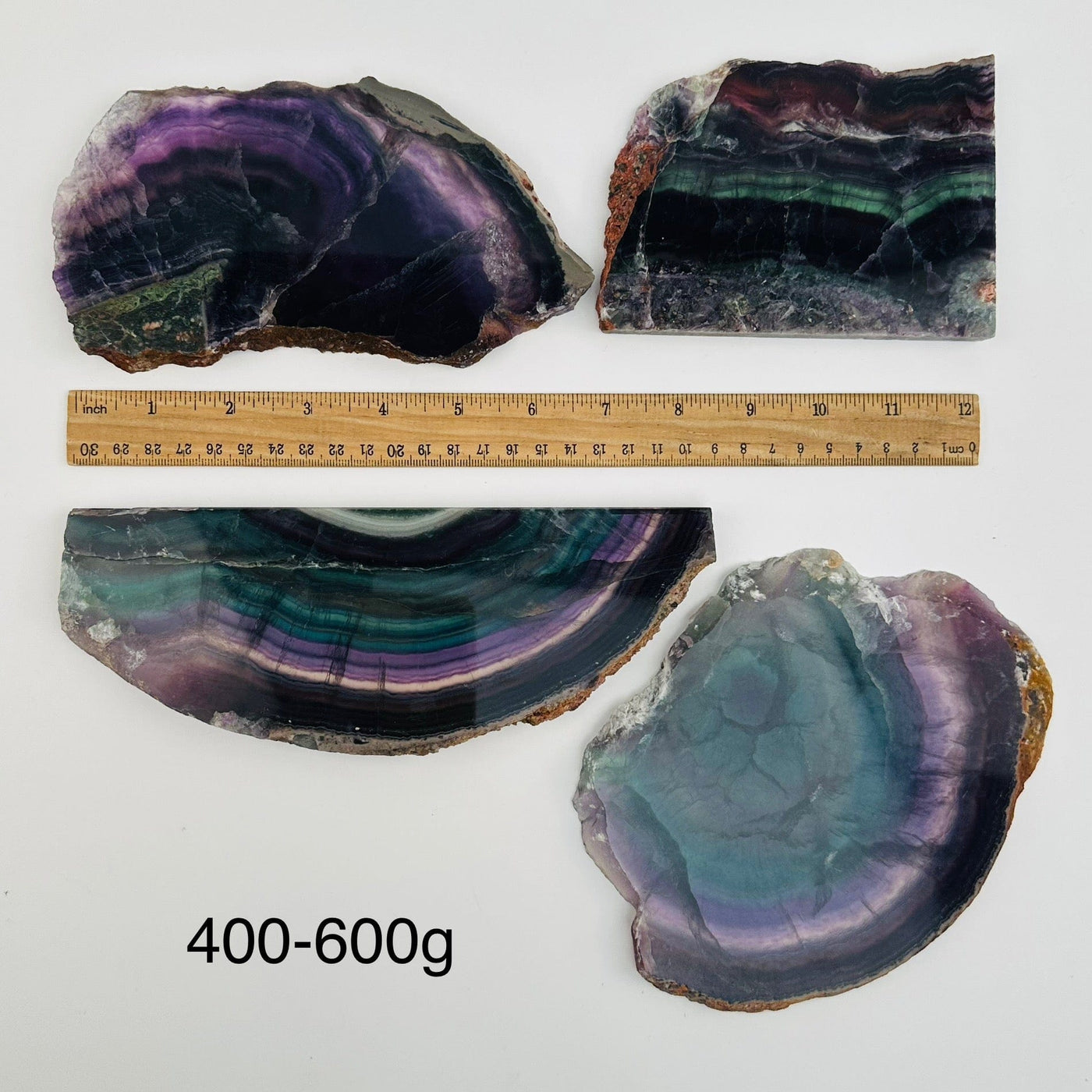 fluorite semi polished crystal slabs sold by weight. displayed next to a ruler for size reference 