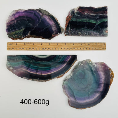 fluorite semi polished crystal slabs sold by weight. displayed next to a ruler for size reference 