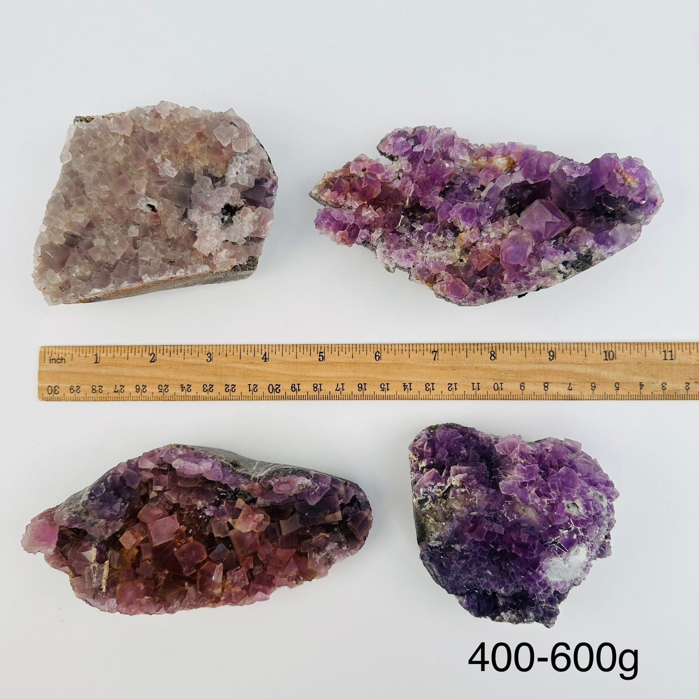 fluorite crystal clusters sold by weight. displayed next to a ruler for size reference 