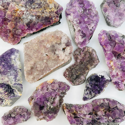 multiple fluorite clusters displayed to show the differences in the sizes and color shades 