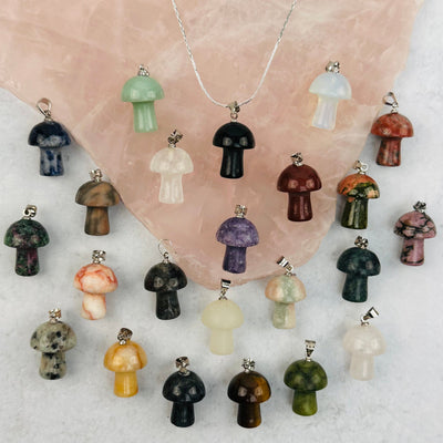 multiple mushroom pendants displayed to show the differences in the gemstone types 