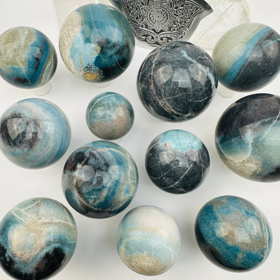 multiple crystal spheres displayed to show the differences in the sizes and color shades 