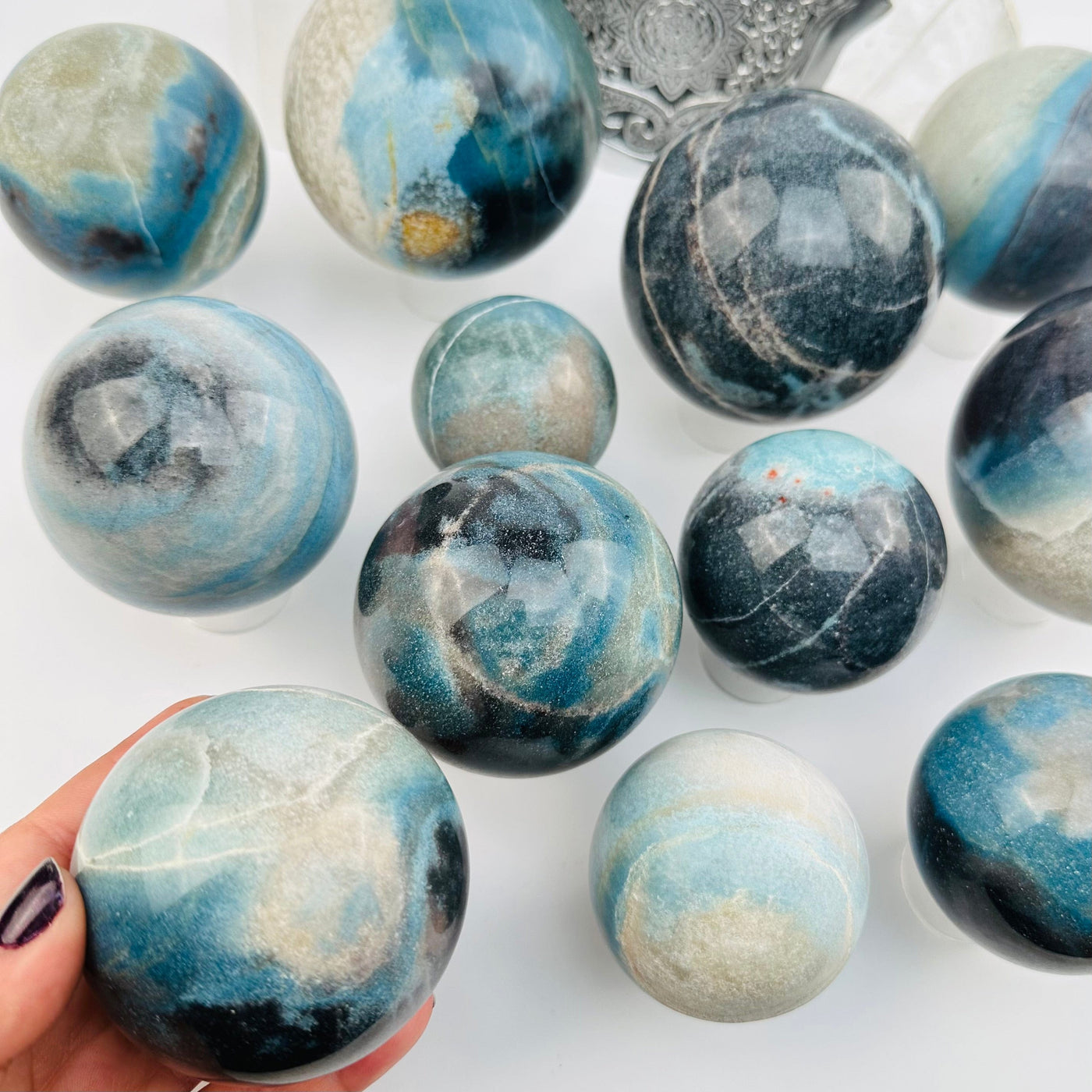 crystal trolleite sphere in hand for size reference 