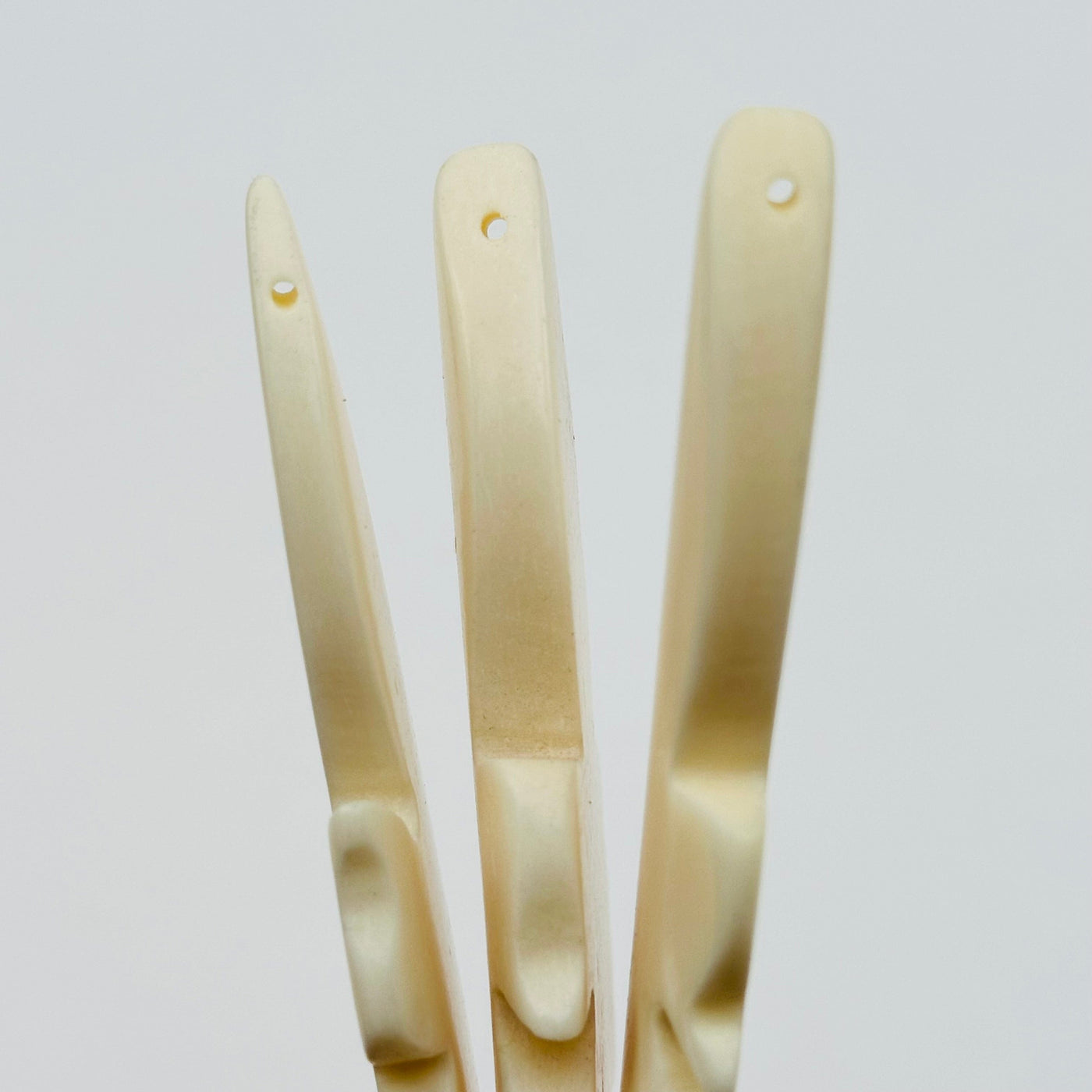 close up of the drilled holes on these carved beads 