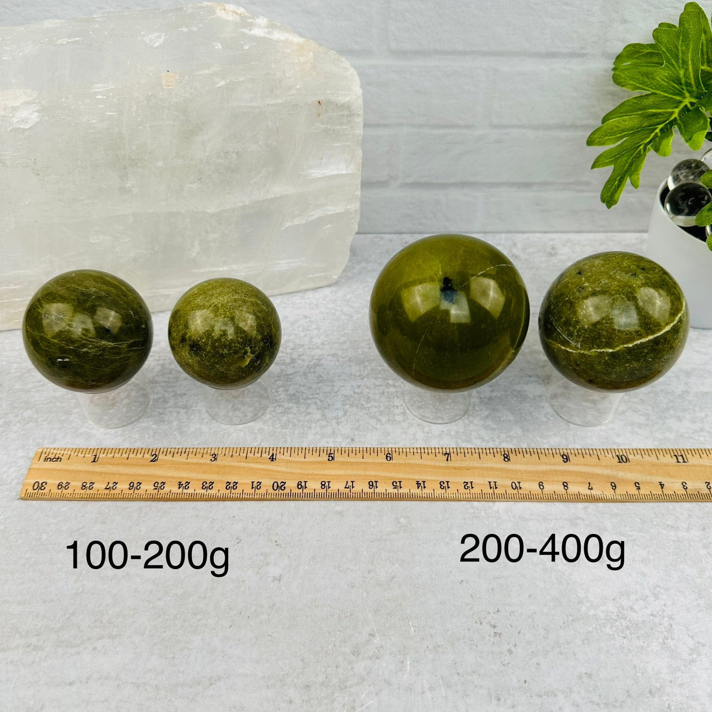 Green Jade Polished Spheres - BY WEIGHT - next to a ruler for size reference 