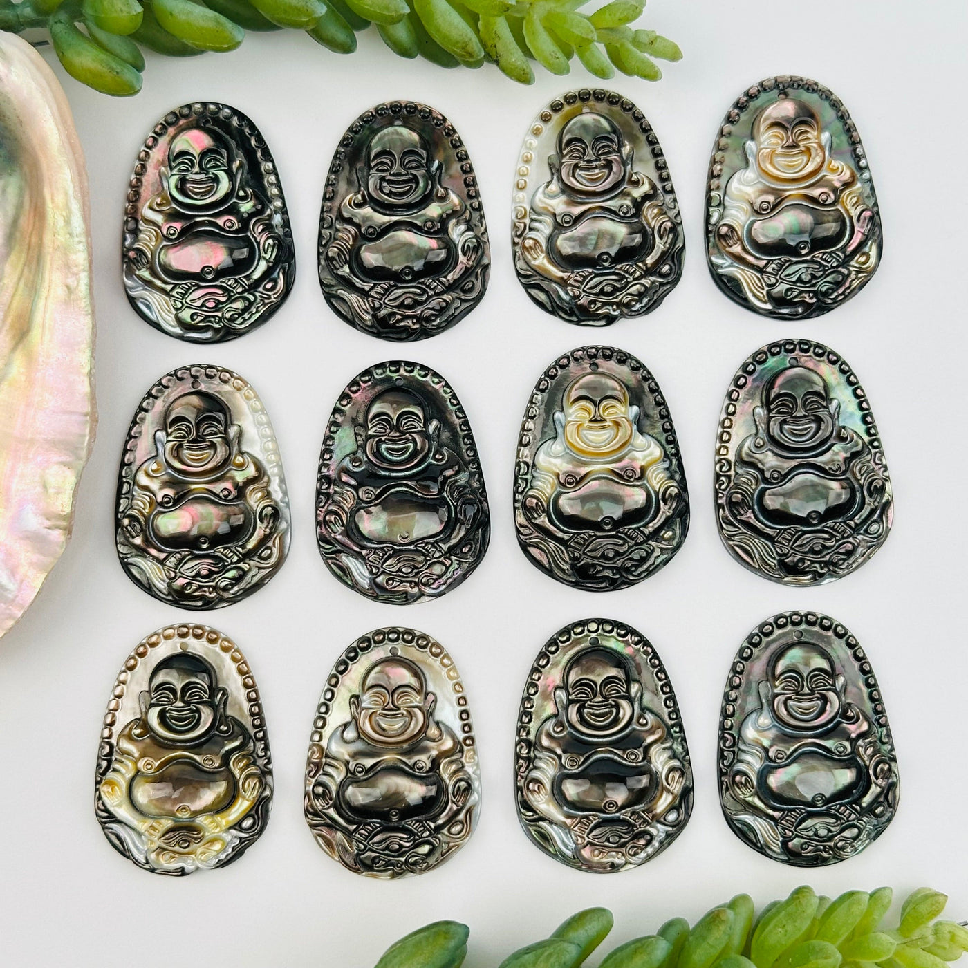 multiple buddha head pendants displayed to show the differences in the color shades 