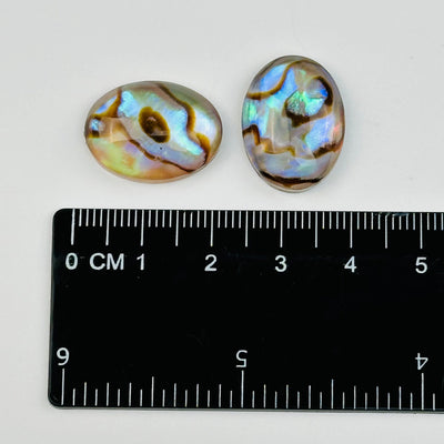 cabochons next to a ruler for size reference 
