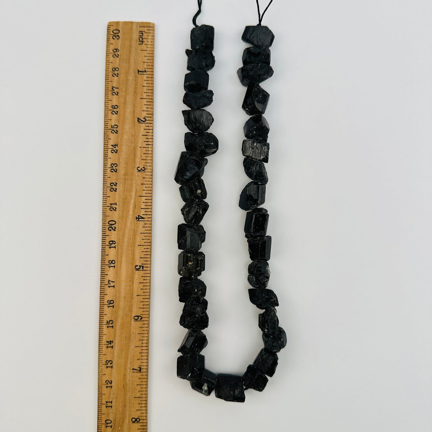 crystal beads next to a ruler for size reference 