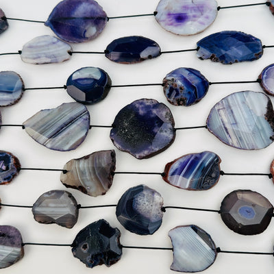 multiple bead strands displayed to show the differences in the color shades and bead sizes 