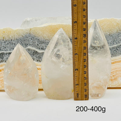 crystal quartz flame points sold by weight. displayed next to a ruler for size reference 