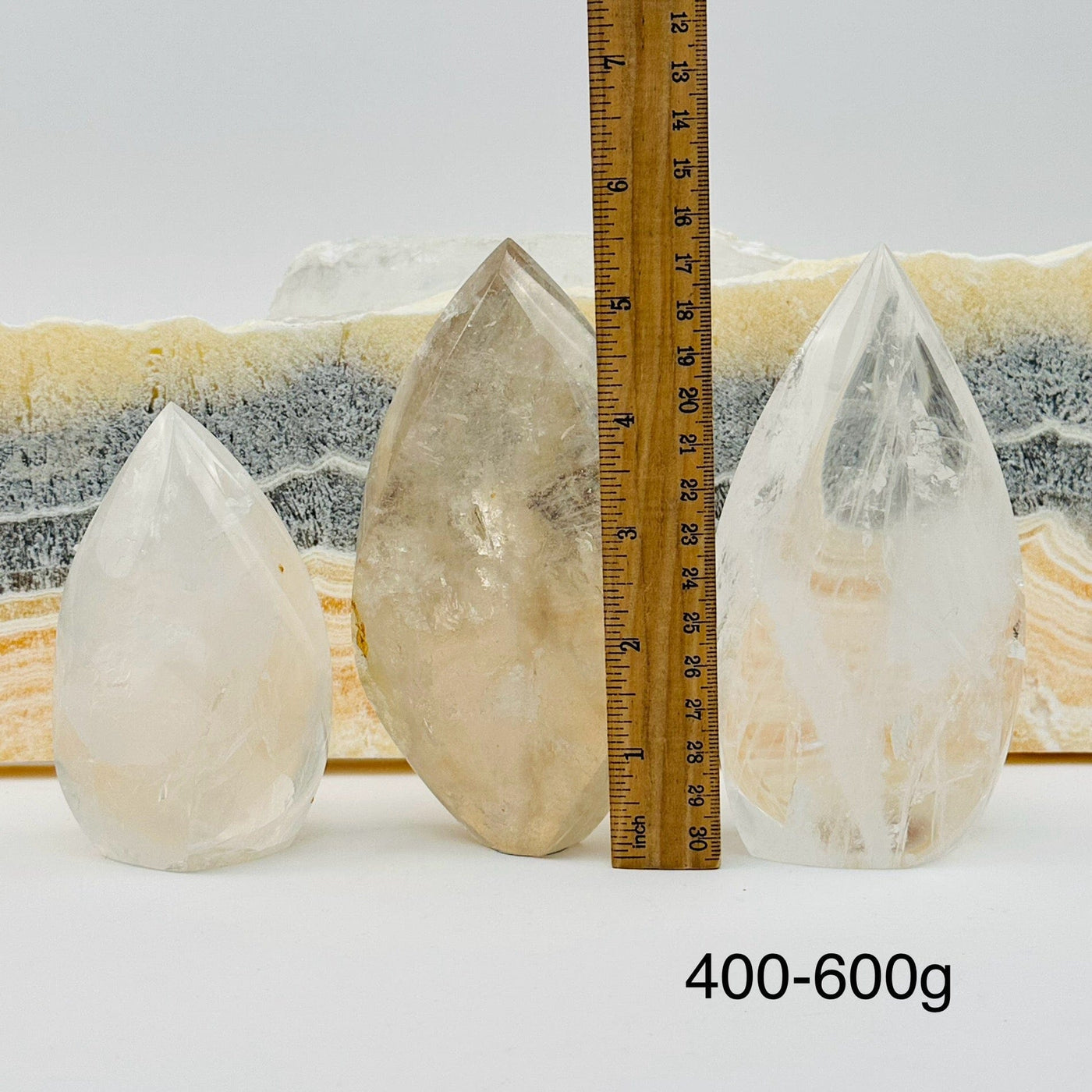 crystal quartz flame points sold by weight. displayed next to a ruler for size reference 