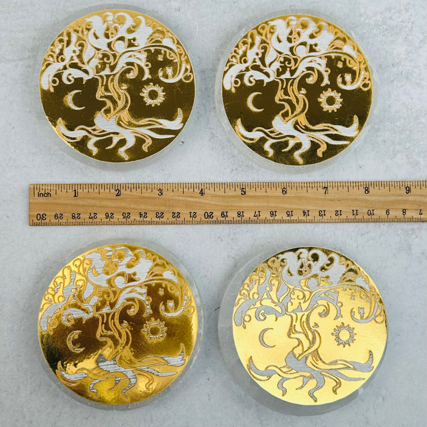 Selenite Round Charging Plate - Gold Tree of Life Design next to a ruler for size reference 
