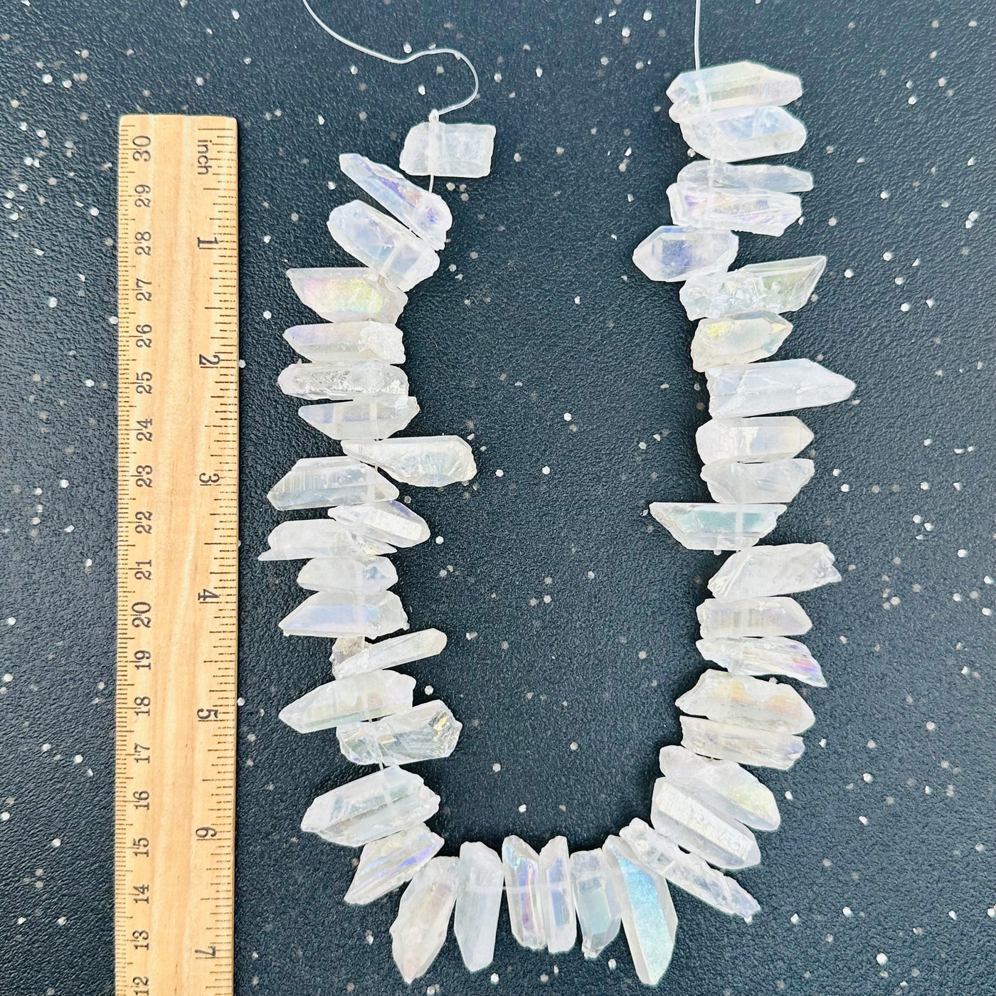 crystal beads displayed next to a ruler for size reference 